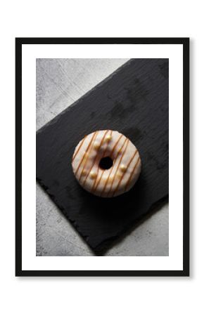 Sweet Cinnamon Roll Donut with White Icing on Charred Black Wood