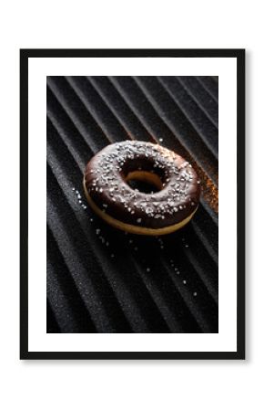 Chocolate Glazed Donut with Coconut on Black Metal Grill Texture