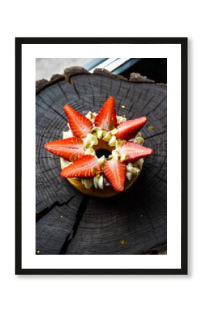 Gourmet Donut Topped with Strawberries and Kiwi on Rough Wooden Log