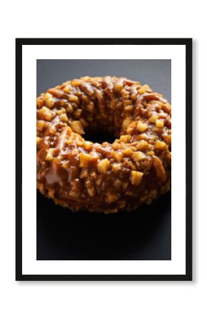 Close-up of Glossy Nut and Caramel Glazed Donut on Dark Background