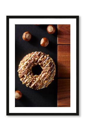 Hazelnut Drizzle Donut with Nuts on Black Slate and Wood Surface