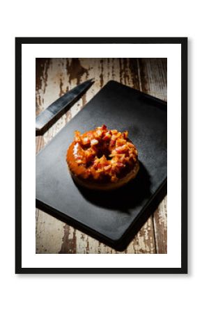 Gourmet Apple Crumble Fritter Donut on a Dark Slate Plate with Knife