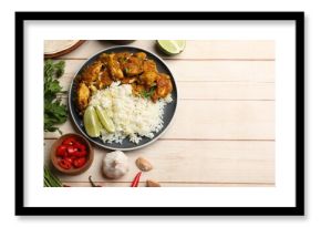 Delicious chicken tikka masala with rice, parsley, lime and spices on light wooden table, flat lay. Space for text