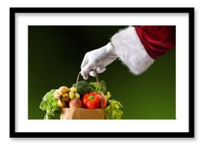 Santa's hand holding a bag full of food isolated background