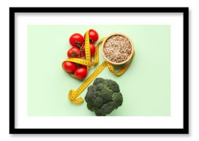 Fresh vegetables, bowl of seeds and yellow measuring tape on green background. Diet concept