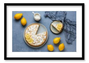 Plate with tasty lemon pie and jug of milk on blue grunge background