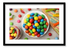 Delicious colorful candies on light table, flat lay