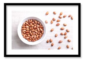 Cranberry beans, Borlotti beans in white bowl on linen. Tan colored, streaked with red variety of the common bean Phaseolus vulgaris, also known as Borlotto, Roman, saluggia, gadhra or rosecoco bean.