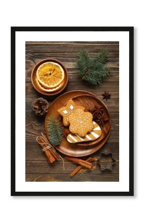 Plate with tasty Christmas cookies and decor on brown wooden background