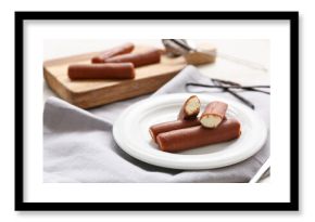 Powdered coffee and tasty curd bars on plate with vanilla on grey background