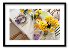 Beautiful table setting with daffodils and candles for wedding celebration in room, top view