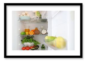 Different fresh products in fridge in kitchen. Closeup