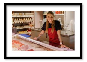 A cheerful fishmonger warmly engages customers at a vibrant and bustling seafood market, overflowing with freshness