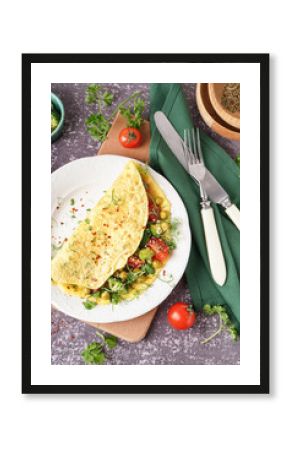 Tasty omelet with vegetables on grey grunge background
