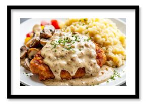 Breaded cutlet with mushroom sauce, mashed potatoes and mushrooms on white plate