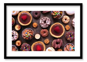 Dessert background with a selection of sweets. Top view on a dark stone background.