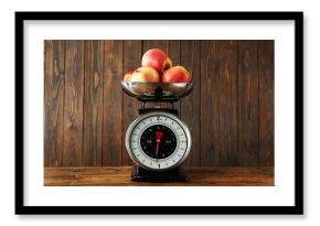 Retro mechanical kitchen scale with apples on wooden table