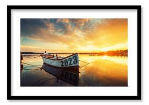 2023 happy new year concept. Fishing Boat on Varna lake with a reflection in the water at sunset. Nature landscape.
