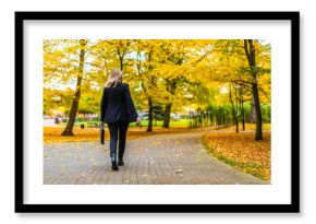 Beautiful woman walking in city park 