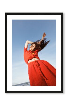 Joyful Woman Dancing in the Summer Breeze, Embracing Freedom and Smiling under the Blue Sky