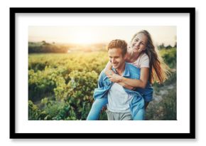 Excited couple, nature and piggyback for travel, adventure and tourism on holiday together with romance. Happy young people walking with support, love and fun by meadow, farm or countryside vacation