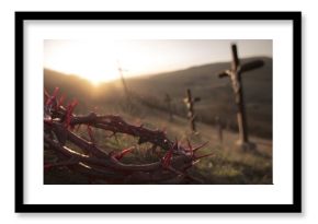 Crown of thorns and bloody nails lying on rocky ground at sunset, with blurred crosses on distant hill and dramatic light flare, symbolizing sacrifice, pain, redemption, and spiritual devotion
