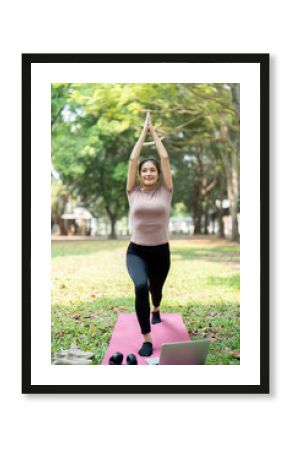 Wellness and Fitness Routine. A woman practicing yoga outdoors, enhancing her physical and mental well-being.