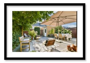 A beautifully designed outdoor patio featuring lush greenery, comfortable seating, and an inviting dining setup under a stylish umbrella.