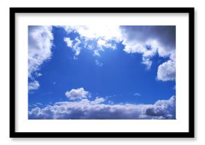 Bright blue sky framed by fluffy white and dark clouds. Inspiring, peaceful, and perfect for adding depth to design projects, websites, or marketing campaigns.