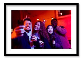 Friends enjoying a night out at a party with drinks and vibrant lights in an urban setting