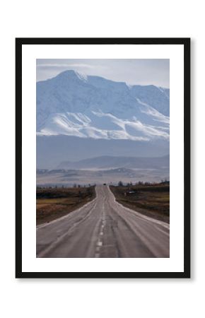 Beautiful autumn road with snow-covered peaks mountains North Chuya mountain ridge in Altai, Siberia, Russia