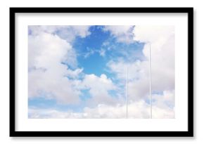 Pair of tall white poles are rising against wide cloudy sky in vector flat design illustration