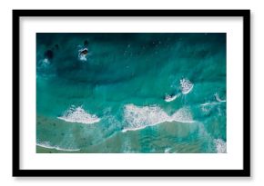 Top down view of blue ocean with crashing waves, drone shot