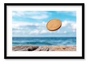 Golden coin is tossed mid air against serene ocean backdrop, evoking sense of wonder