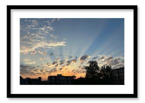 sunset over city with glowing rays