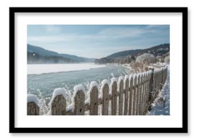 Detailed View of a Frost-Covered Barrier Overlooking a Flowing Waterway