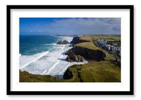 Surf and waves Mawgan Porth north Cornwall England near Newquay and south of Porthcothan and Treyarnon on a summer day with blue sk
