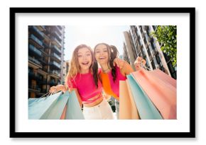 Two cheerful girlfriends shopping in sunny city streets capture friendship fashion and summer vibes while exploring urban life together
