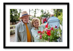 Happy elderly couple enjoying gardening in countryside.