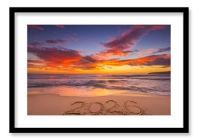 Happy New Year 2026 tropical island, beautiful sunrise over the beach and sea horizon with text 2026 handwritten in the sand