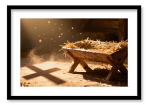 Wooden manger with straw in a rustic stable illuminated by a divine beam of light. Shadow on the ground forms a Christian cross. Nativity and Christmas concept
