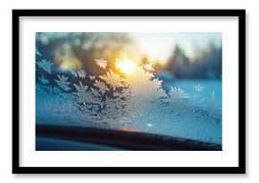 Glistening frost-covered car windshield against a winter sunset, creating a stunning pattern against nature's backdrop. Ideal for winter and holiday projects, capturing the enchantment of the season