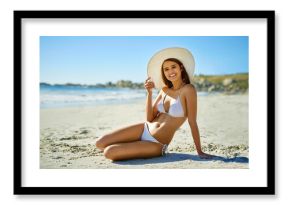 Woman, portrait and hat on beach sand for holiday, vacation or summer adventure by ocean outdoor. Tourist, sun accessory and Miami for smile, confidence and weekend travel with swimsuit for happiness