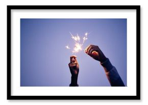 Sparkler, hand and person at night for new years eve celebration with bright, burning fun to celebrate. Celebrating, sparkle and blue nighttime background with a firework or firecracker in hands