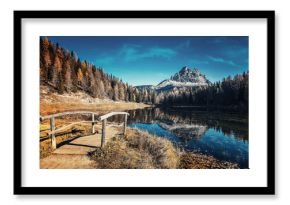 Scenic autumn landscape of mountain lake Antorno. Amazing alpine scenery with perfect blue sky over the calm mountain lake at sunny day. Stunning natural background. Popular travel and hiking place