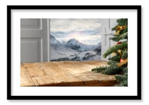 Wooden table, open door, winter landscape and free space