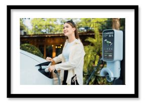 Young woman and sustainable urban commute with EV electric car recharging at outdoor cafe in springtime garden, green city sustainability and environmental friendly EV car. Expedient