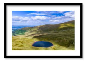 Small glacial lake beneath high mountains (Cwm Llwch, Brecon Beacons)