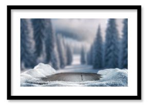 Empty wooden table top coverd with snow with copy space and winter snowing trees and mountain background.