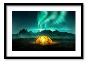 A glowing yellow camping tent under a beautiful green northern lights aurora. Travel adventure landscape background. Photo composite.